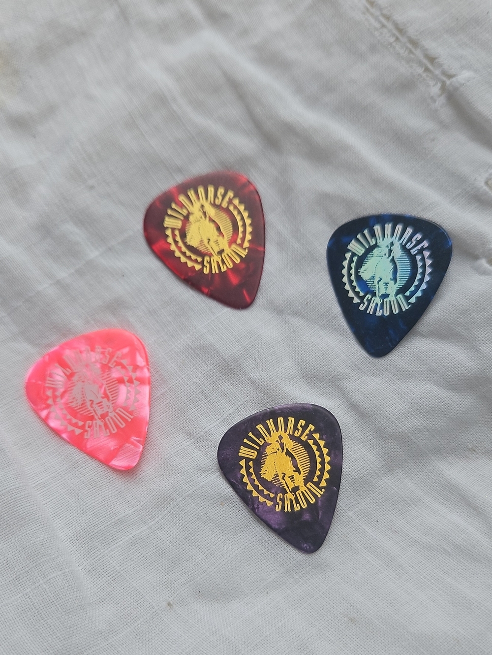 Wildhorse Saloon celluloid guitar picks featuring gold foil logo brand